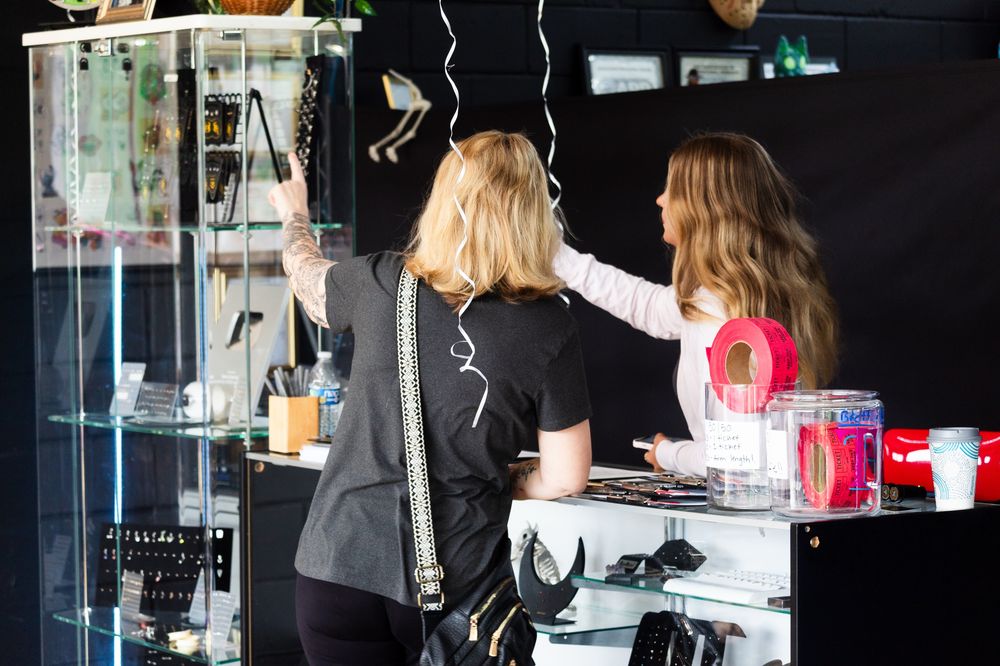 Picking out piercing jewelry at the Space Coast Ink counter